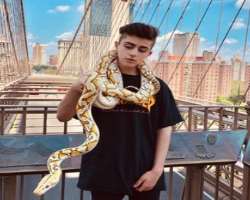 He is an animal lover and isn't afraid to hold a big python.